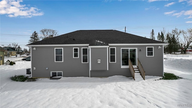 view of snow covered rear of property