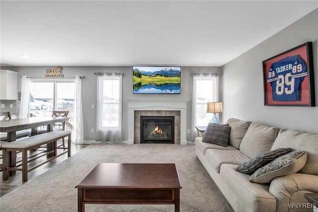 carpeted living room featuring a tile fireplace