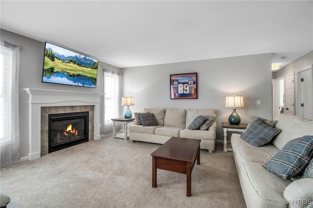 carpeted living room with a tile fireplace