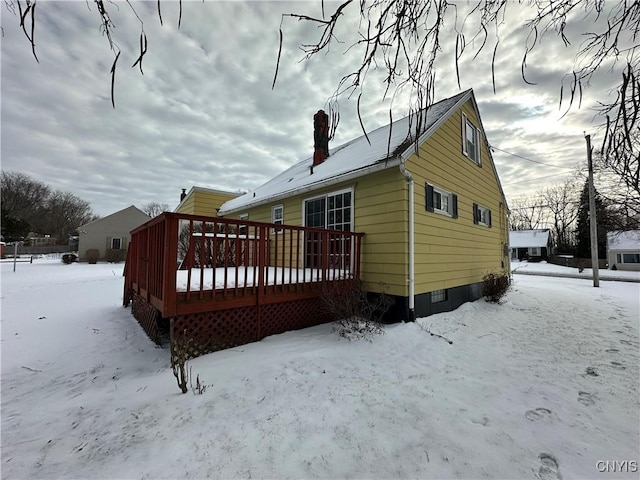 snow covered property featuring a wooden deck