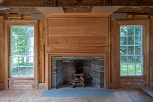 room details featuring hardwood / wood-style floors and a stone fireplace