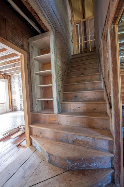 stairs with hardwood / wood-style floors