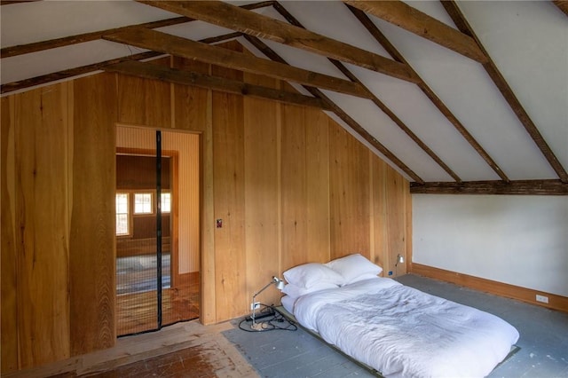 bedroom with wooden walls and lofted ceiling