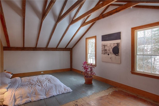 interior space with hardwood / wood-style flooring and lofted ceiling with beams