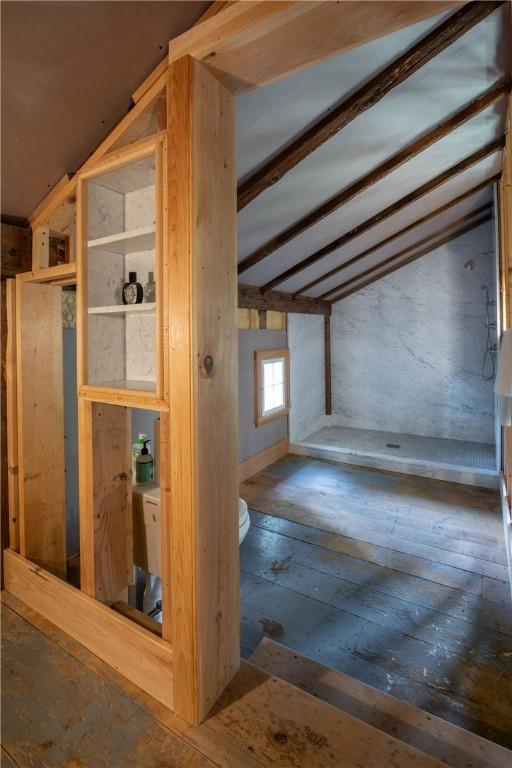 interior space featuring hardwood / wood-style floors, built in features, and lofted ceiling