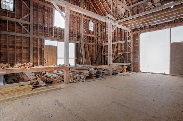 misc room with a healthy amount of sunlight and a towering ceiling