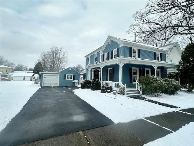 view of front of property with an outbuilding, a garage, and covered porch