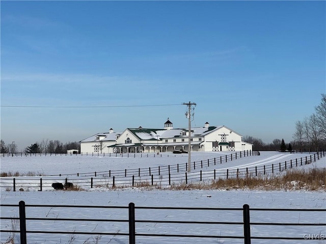 snowy yard with a rural view