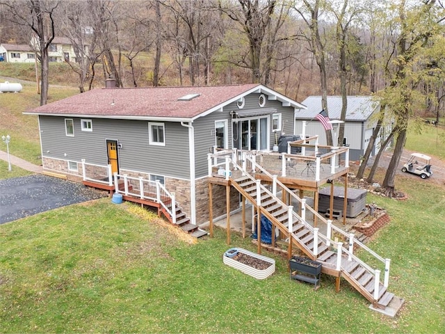 rear view of property with a lawn and a wooden deck