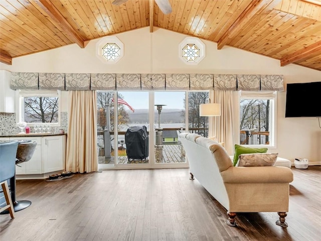 unfurnished living room featuring hardwood / wood-style floors, ceiling fan, and wood ceiling