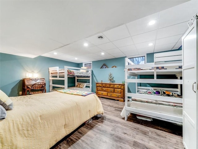 bedroom with hardwood / wood-style flooring and a drop ceiling