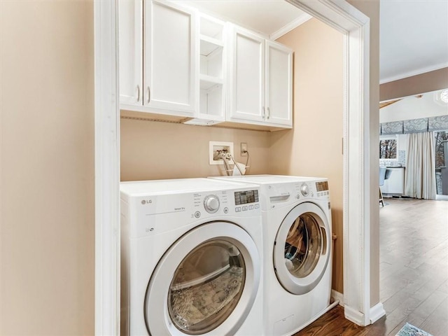 laundry area with cabinets, separate washer and dryer, ornamental molding, and dark wood-type flooring