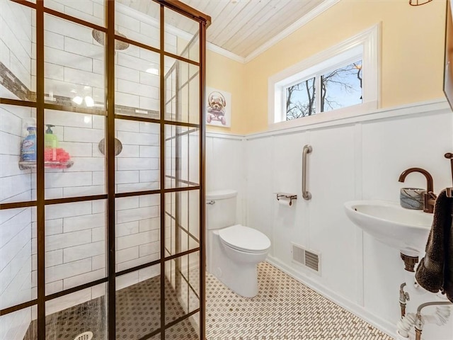 bathroom featuring tile patterned floors, toilet, ornamental molding, and sink