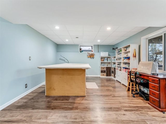 office space featuring a drop ceiling and light hardwood / wood-style floors