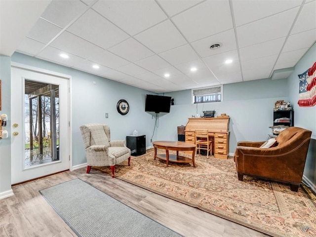 sitting room featuring a paneled ceiling and light wood-type flooring