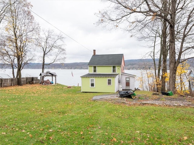 exterior space featuring a yard and a water view