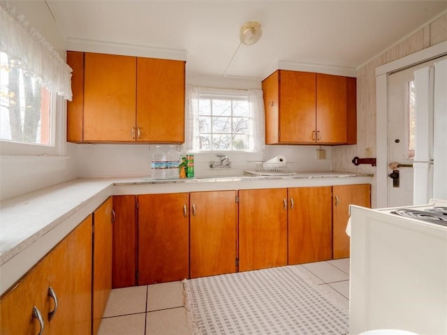 kitchen featuring crown molding and light tile patterned flooring