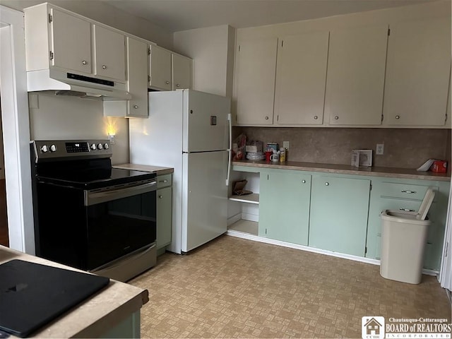 kitchen featuring white cabinets, white fridge, stainless steel electric range oven, and tasteful backsplash