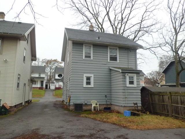 rear view of property with central AC