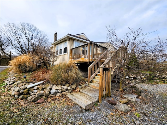 back of house with a wooden deck