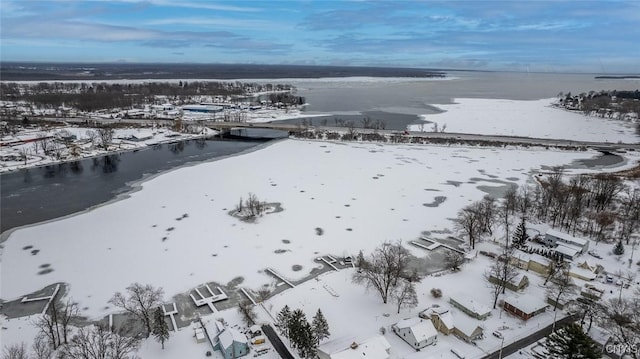 snowy aerial view featuring a water view