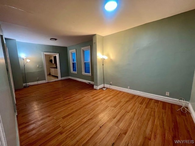 unfurnished room with hardwood / wood-style flooring