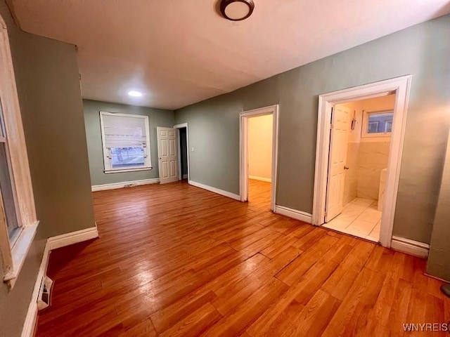 interior space featuring connected bathroom and light hardwood / wood-style flooring