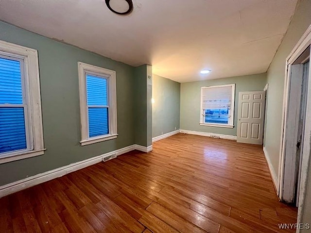 spare room featuring hardwood / wood-style flooring