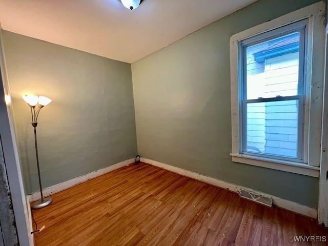 spare room with hardwood / wood-style flooring