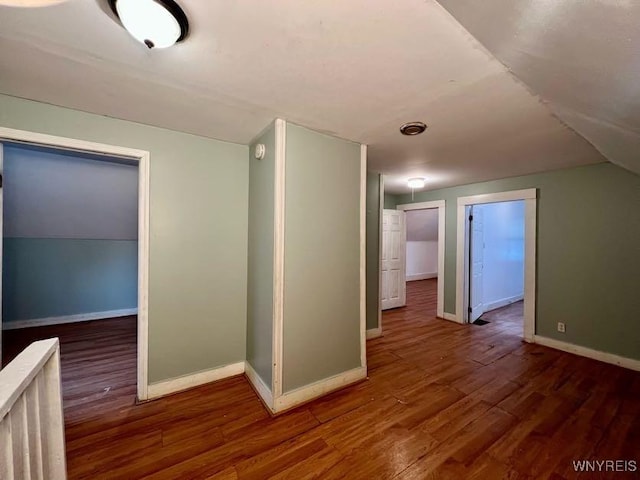 additional living space with dark hardwood / wood-style flooring