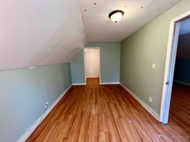 bonus room with light hardwood / wood-style floors and lofted ceiling