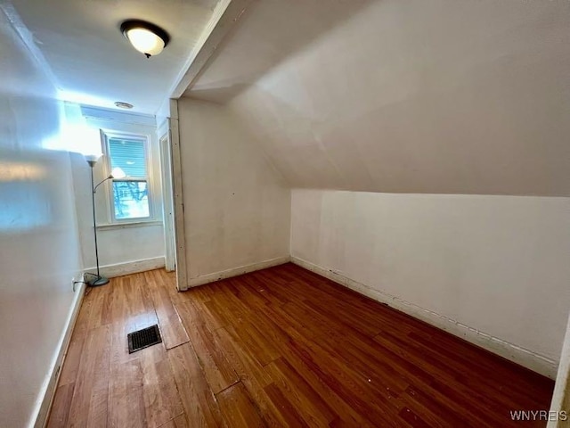 bonus room featuring vaulted ceiling and hardwood / wood-style flooring