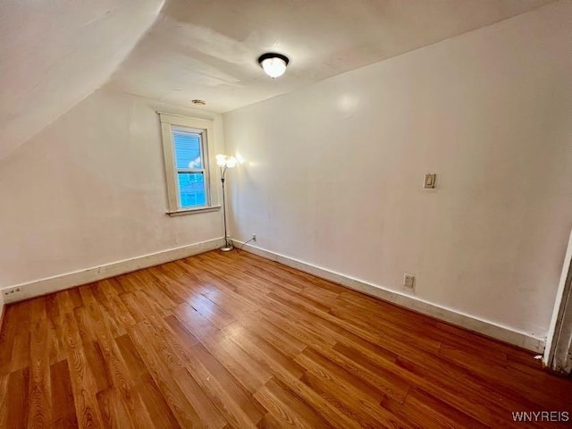 bonus room featuring hardwood / wood-style floors and lofted ceiling