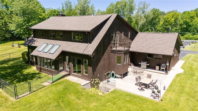 back of house with a sunroom, a yard, and a patio