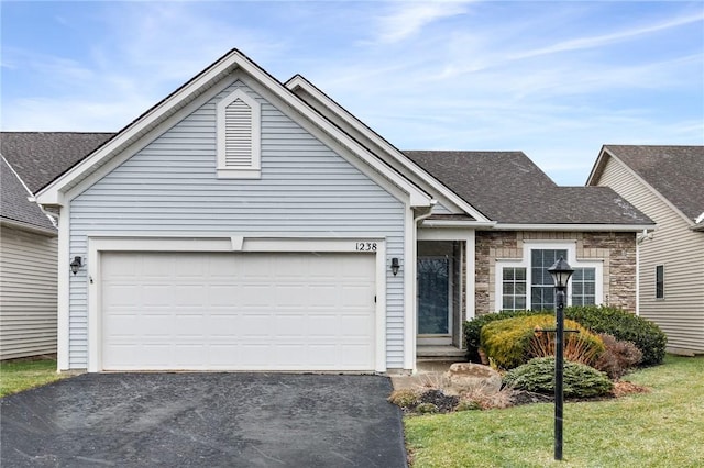 view of front facade featuring a front yard and a garage