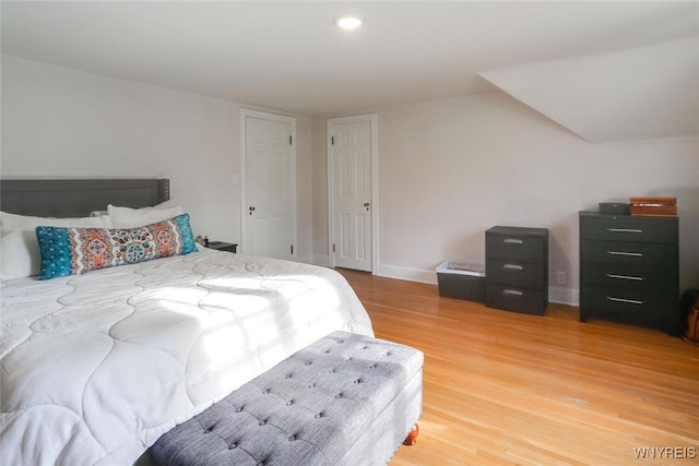 bedroom featuring light wood-type flooring and baseboards