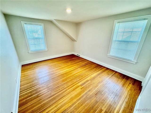 unfurnished room with wood finished floors and baseboards