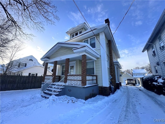 view of front of property featuring a porch, a garage, and an outdoor structure