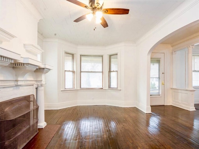 unfurnished living room featuring ceiling fan, crown molding, and dark hardwood / wood-style floors