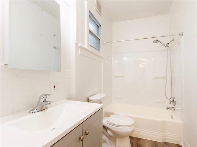 full bathroom with vanity, backsplash, toilet, wood-type flooring, and tub / shower combination