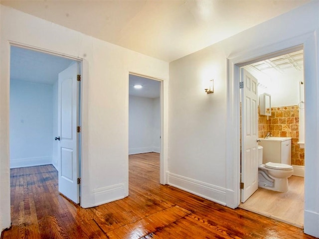 corridor featuring wood-type flooring