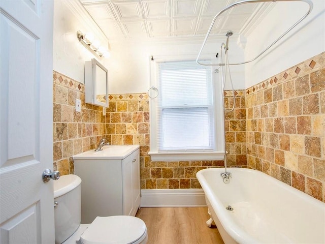 bathroom with hardwood / wood-style flooring, vanity, and toilet