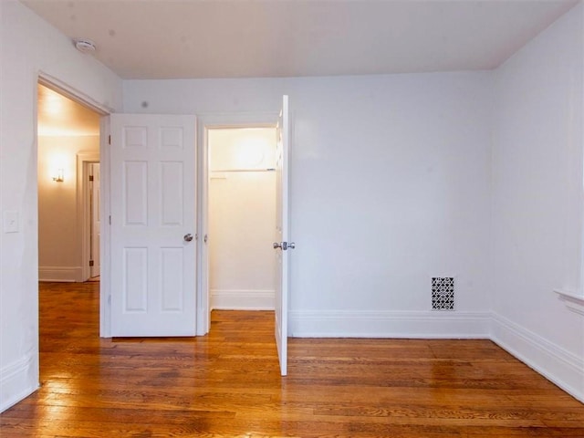 unfurnished bedroom featuring hardwood / wood-style flooring