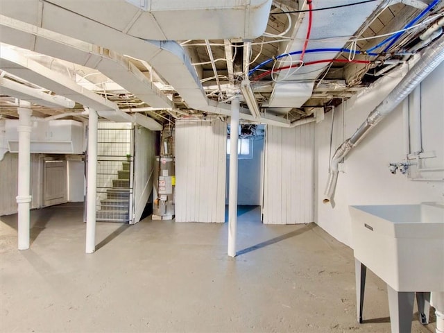 basement featuring water heater and sink