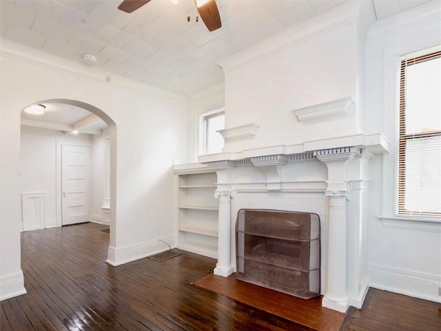 unfurnished living room with dark hardwood / wood-style floors, ceiling fan, and ornamental molding