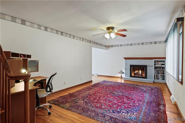 home office with hardwood / wood-style flooring, ceiling fan, and a healthy amount of sunlight