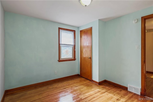 unfurnished bedroom with light hardwood / wood-style flooring and a closet