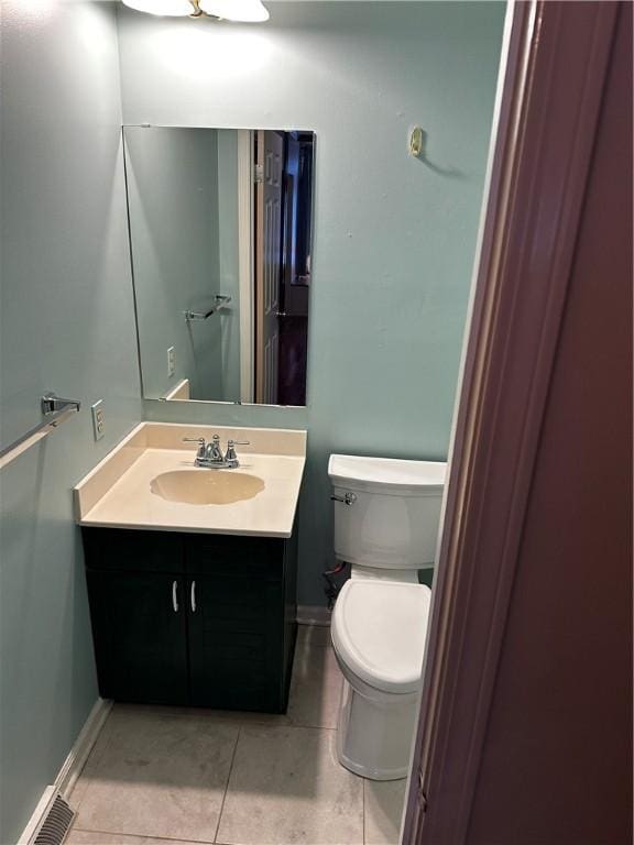 bathroom with tile patterned floors, vanity, and toilet