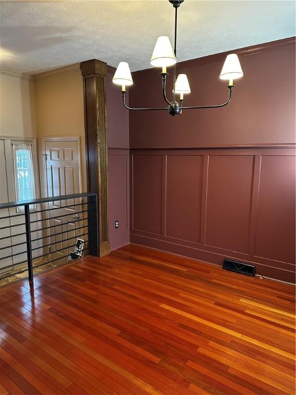 interior space with hardwood / wood-style floors and a textured ceiling