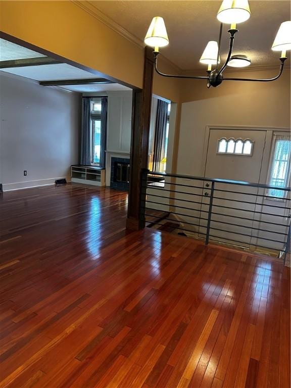 spare room featuring dark hardwood / wood-style floors, plenty of natural light, and ornamental molding